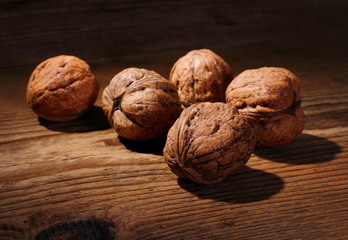 Five powerful walnuts on wooden background
