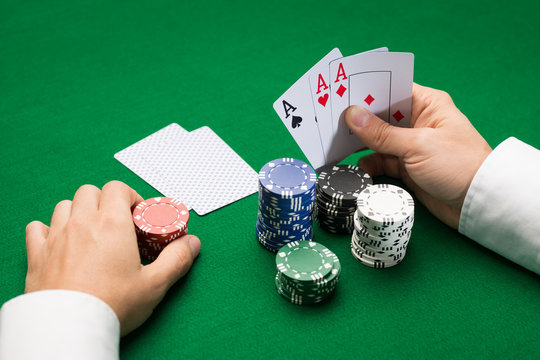 poker player with cards and chips at casino