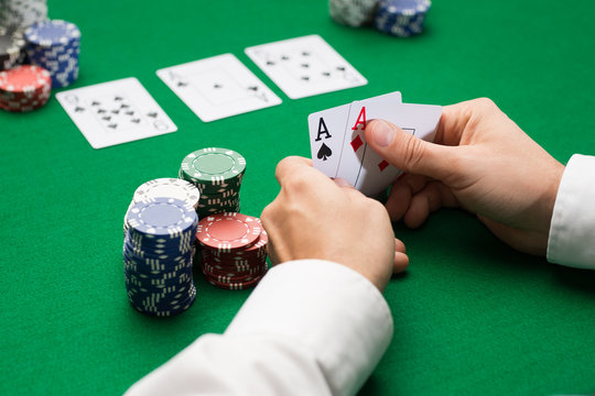 poker player with cards and chips at casino