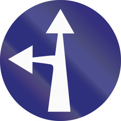 Old design (1956) of a German sign restricting the driving direction to straight forward or left