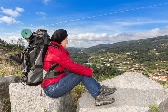 Woman traveler with a backpack resting.