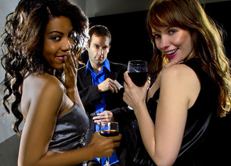 women seducing a man at a bar or nightclub