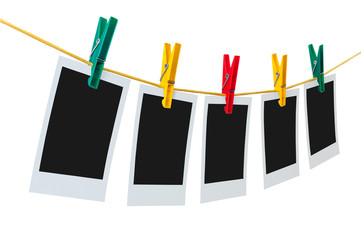 Five blank instant photos on clothesline