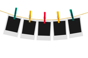 Five blank instant photos on clothesline