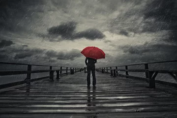 Tuinposter Red umbrella in storm © Kevin Carden