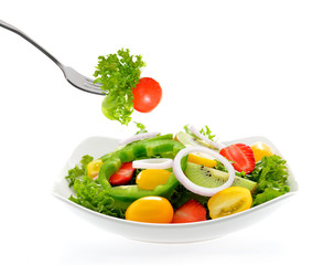 Fruit and vegetable salad in a bowl isolated on white