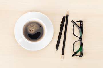 Office desk with coffee cup, supplies and glasses