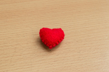red heart on wooden table