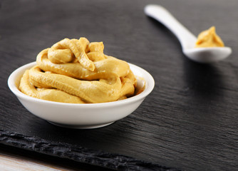 Mustard sauce in a white bowl