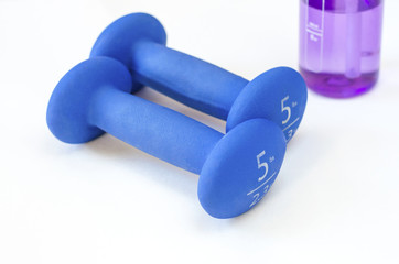 A pair of hand weights and a water bottle