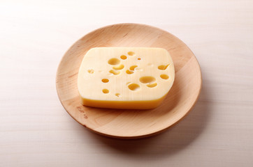 Cheese on wooden plate