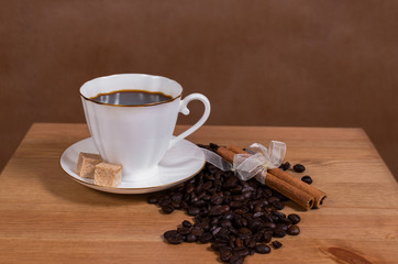 black coffee in a white cup on a brown background
