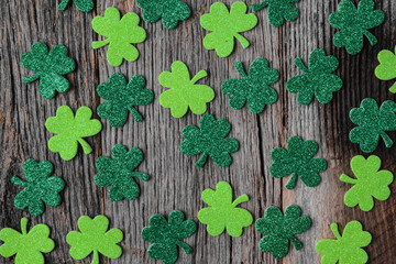 Green Clovers or Shamrocks  on Rustic Wood Background Background