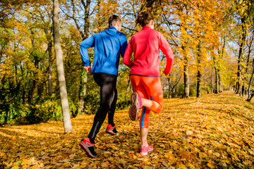 Couple jogging in autumn nature