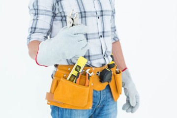 Fototapeta na wymiar Technician with tool belt around waist holding pliers