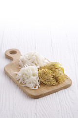 chinese dry noodle in wooden dish on white background