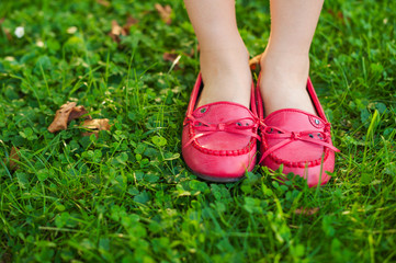 Close up of red moccasins on child's feet