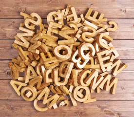 Pile of wooden letters over the wooden surface