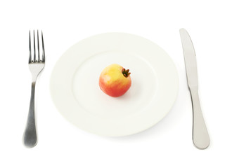 Pomegranate fruit in a plate isolated