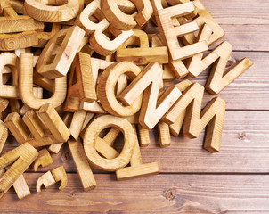 Pile of wooden letters over the wooden surface