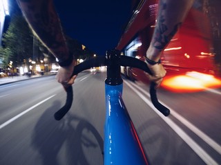 Fast riding in traffic in night streets of city