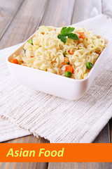 Asian noodles in bowl with vegetables and space for your text