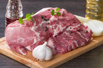 Fresh raw pork on light wooden cutting board