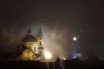 Fototapeta na wymiar Night fog over Saint Nicholas Church in Prague, Czech Republic.