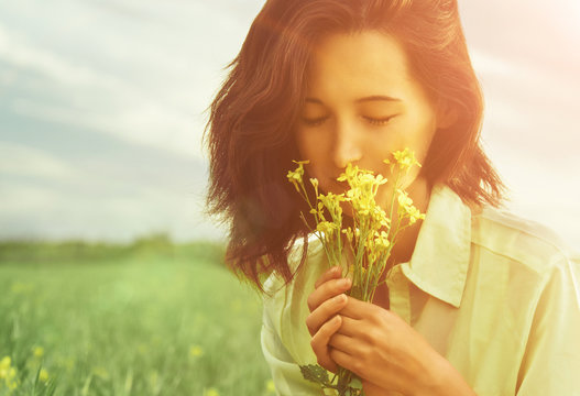 Woman Smelling Flowers In Summer