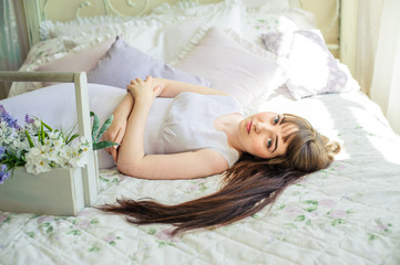 Naklejka premium one young girl on the bed