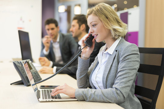 Businesswoman Talking On The Phone In Modern Office