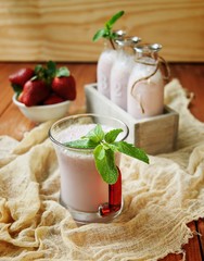 Strawberry milkshake on a rustic wooden table