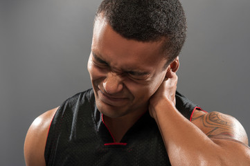 Young handsome African basketball player feeling pain