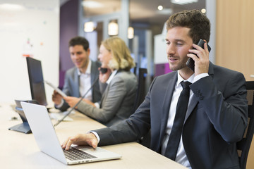 Businessman talking on the mobile phone in modern office