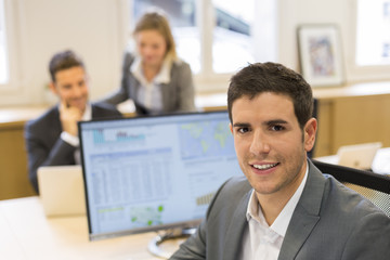 Portrait of handsome businessman in office. looking camera
