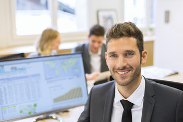 Portrait of handsome businessman in office. looking camera