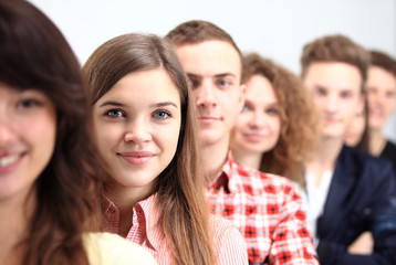 Happy Smiling Students Standing In Row