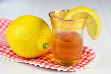 Lemon tea in a little tea glass with lemons