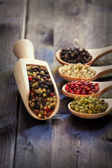 Mixed peppercorns in a wooden spoon