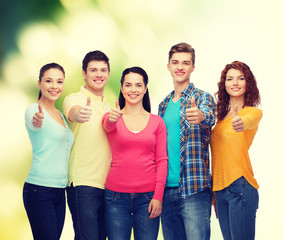 group of smiling teenagers over green background