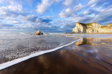 Sopelana beach with wave foam and reflections