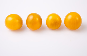 Yellow shiny cherry tomatoes