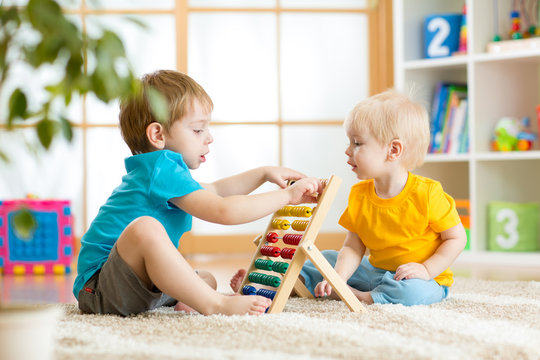 children boys playing with abacus