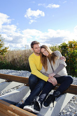 Happy couple embracing and wearing warm clothes outside
