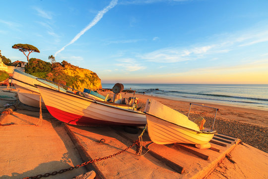 Boats in warm sunset light on the Fisherman's Beach in Albufeira