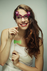 Playful young women holding a party glasses.