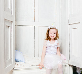 Little girl in wardrobe