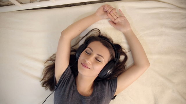 Woman in Love Listening Music in Bed