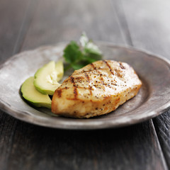 grilled chicken with cilantro and avocado on metal plate