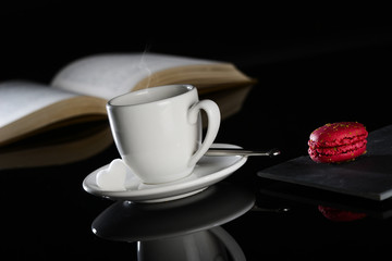 hot drink black espresso coffee with a book and macaroon
